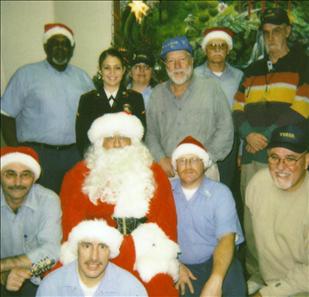 san-quentin-xmas Santa with VVGSQ members and supporters. San Quentin Prison visiting room - December 18, 2005. The VVGSQ has always supported the San Quentin Christmas Toy Program with toy donations as well as by running the program each year. The Warden has authorized the VVGSQ to sponsor this program and the group purchased the "Santa" suit, beard and wig that is used for an appearance of Santa to the children each year at the visiting room. The program benefits all the children who come to visit family at San Quentin during the Christmas season. Started in 1988, December 2008 will be the 20th year the program has been giving toys to the children who visit San Quentin.