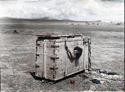 mongolian-crate Stéphane Passet. Mongolian prisoner in a box, July 1913. Image courtesy of BBC. © Musée Albert Kahn