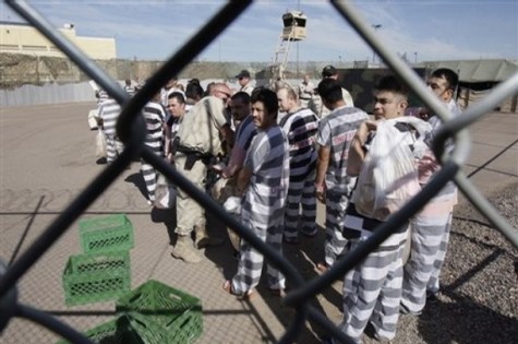 Approximately 200 convicted illegal immigrants handcuffed together arrive at their new part of the jail as they are moved into a separate area of Tent City, by orders of Maricopa County Sheriff Joe Arpaio, for incarceration until their sentences are served and they are deported to their home countries Wednesday, Feb. 4, 2009, in Phoenix. (AP Photo/Ross D. Franklin)