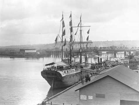 Around 1916, the exhibition prison ship "Success," from Melbourne Australia, was docked at the Tacoma Municipal Dock Landing and open for tours. Marvin D. Boland Collection, Tacoma Public Library. Series: G50.1-103 (Unique: 31555)