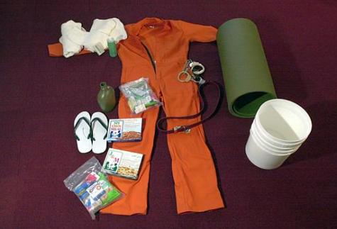 The standard issue of clothing, sleeping mat, food, sandles, canteen, soap, and buckets for detainees of Camp X-Ray is pictured in Camp X-Ray at the U.S. Navy Base at Guantanamo Bay, Cuba, on Wednesday, Feb. 20, 2002. Tomas van Houtryve/AP Photo