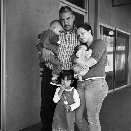 © Joseph Rodriguez. "Jorge Carbajal, 41 years old comes to Walden House for parenting classes and to help his wife Elizabeth and their kids. Here they are all together for their first family portrait in years. He quit his job with the airline KLM which had him traveling all over the world. Jorge says, "I had to help my wife who has a drug addiction problem and I did not want to see my kids wind up in the system." He is a rare individual as he was the only regular father/husband that I got to know who came regularly to meetings." Joseph Rodriguez