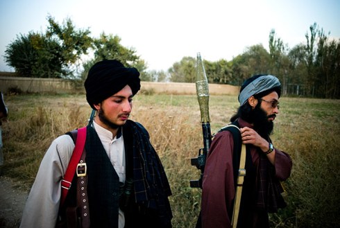 The fighters walk through a landscape of fields, criss-crossed with irrigation canals Photograph: Ghaith Abdul Ahad for the Guardian 