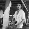 Man cuts open sacks of vegetables to sort through, Louisiana Sta