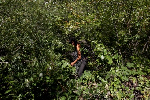 Lucia retrieving her stashed pack in the bushes. California. 2013.