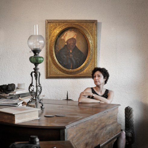 Lorraine Manuel Steed, with the portrait of her ancestor, Martha Adelaide Modeste, an African woman, City Pietonville